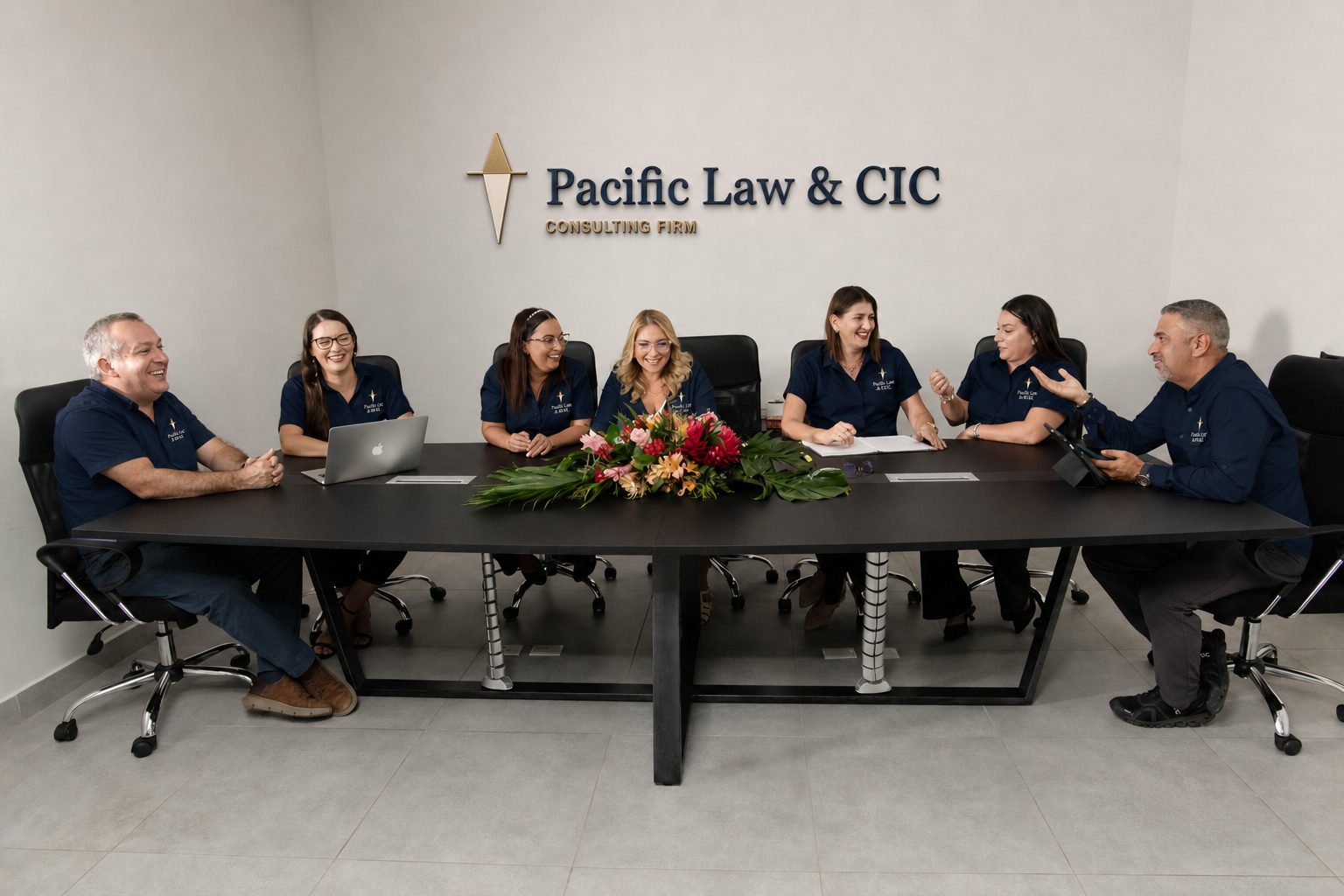 The Pacific Law & CIC team in the boardroom beneath the firm's wall sign